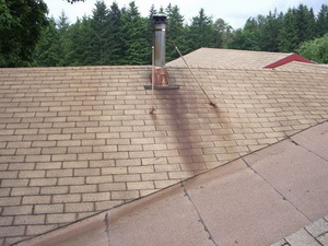 Rust stained stainless steel flue pipe and shingles